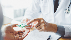 Apotheker gibt Kunde ein Medikament ab Apotheker gibt Kunde ein Medikament ab
