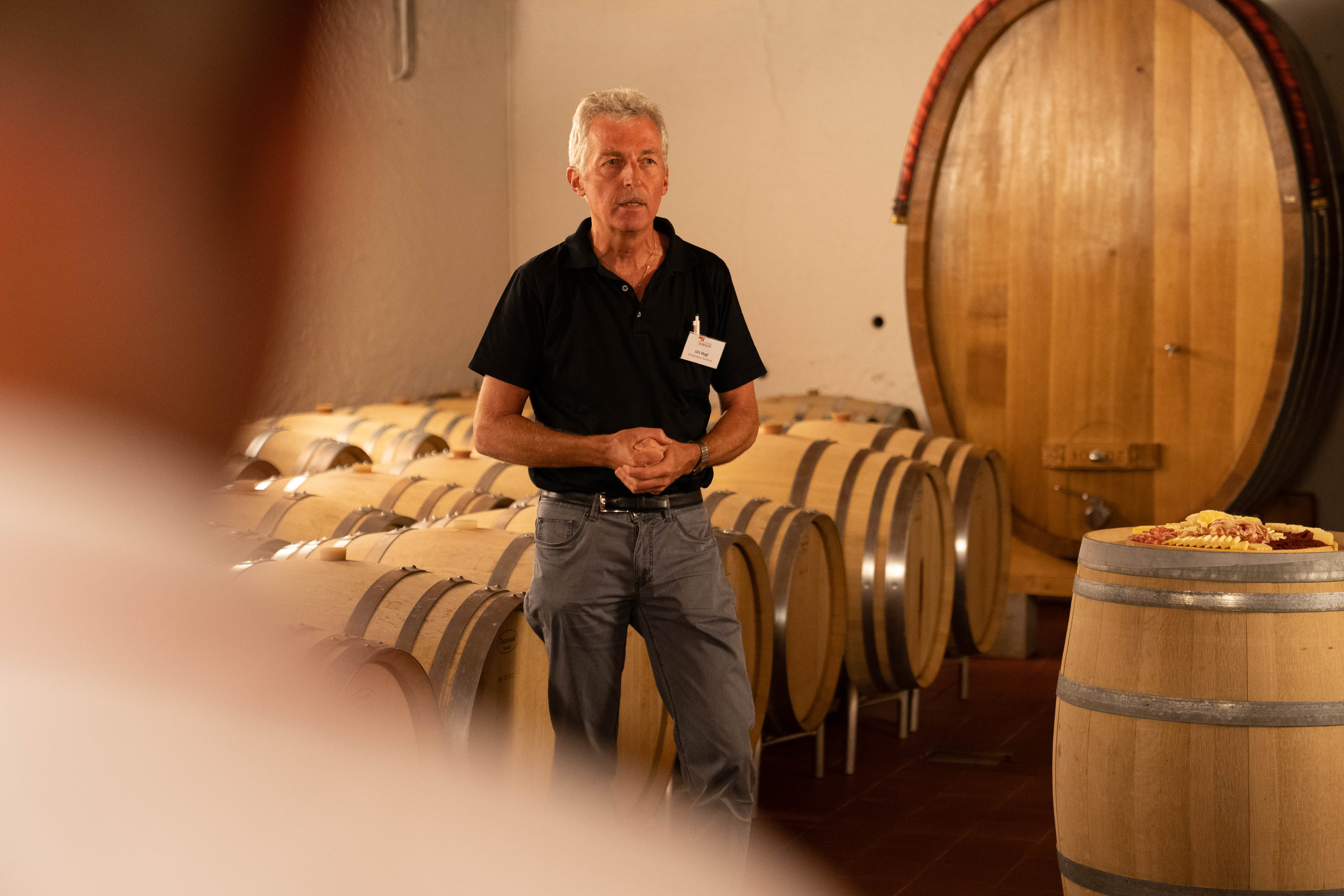 Ein Mann macht eine Führung in einem Weinkeller.